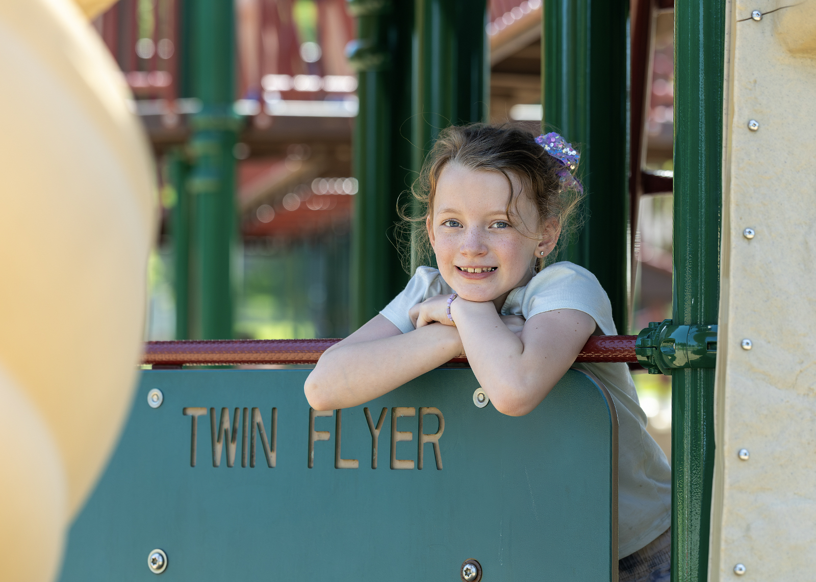 elementary student on playground smiling at camera