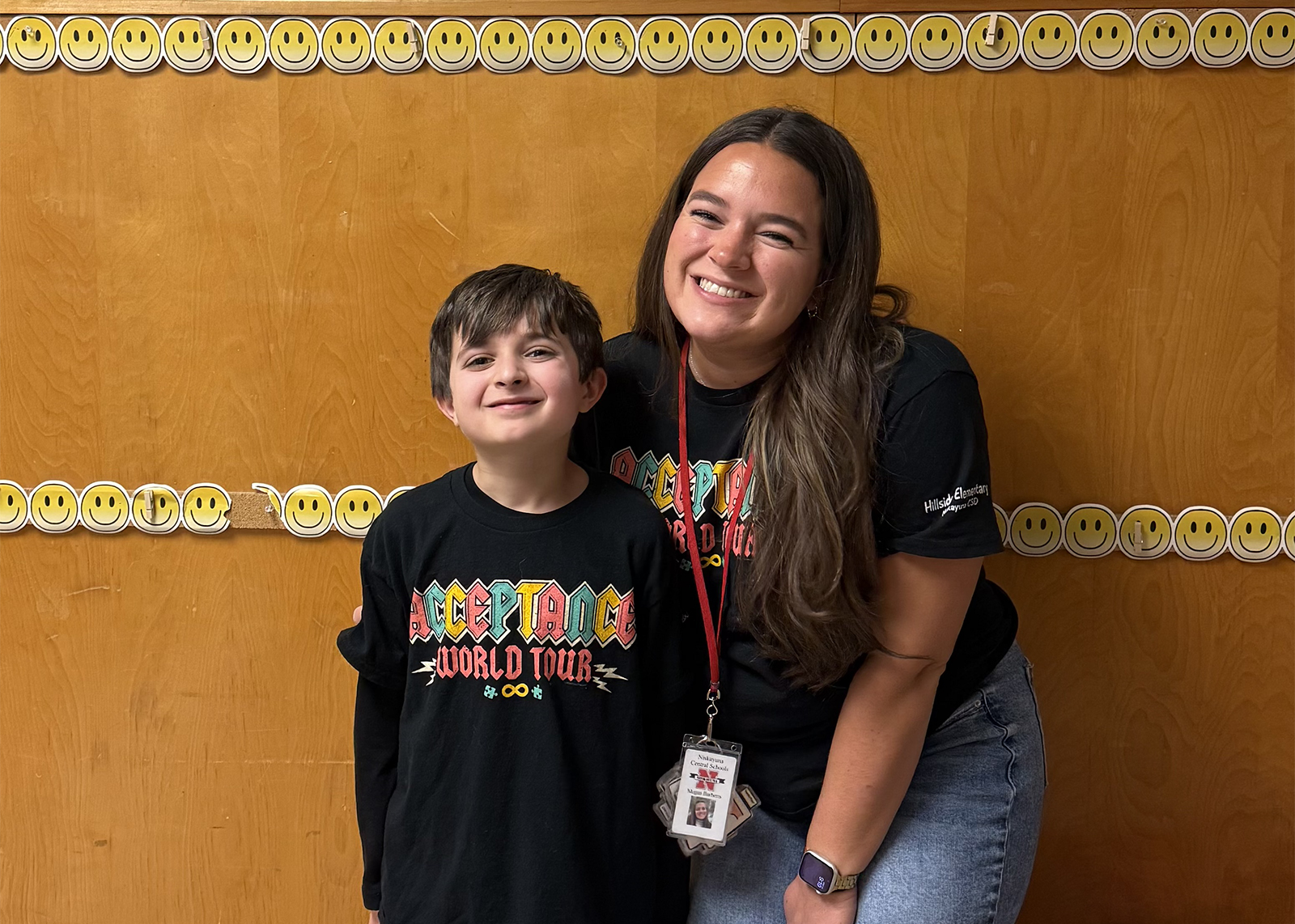 student and educators smiling at camera