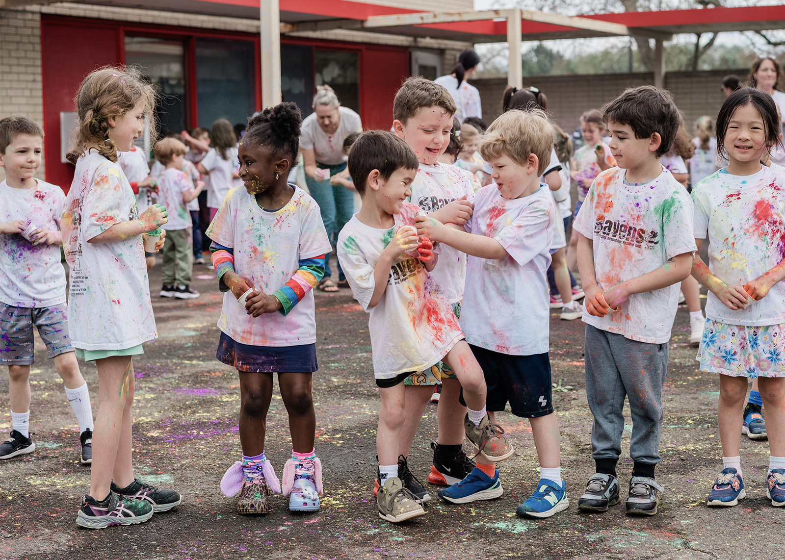 group of elementary kids celebrating Holi with colored powder