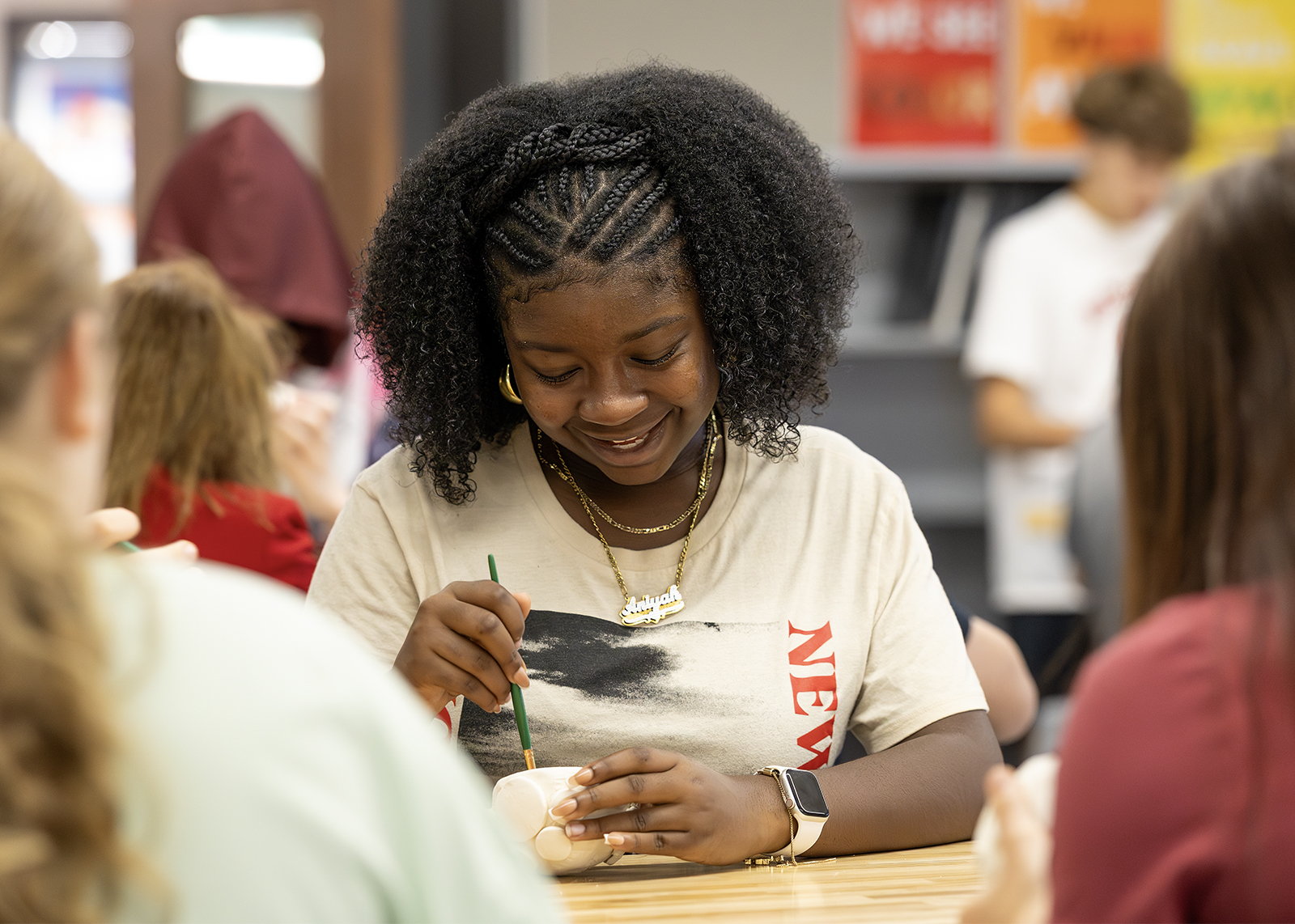 middle school student smiling while working on clay