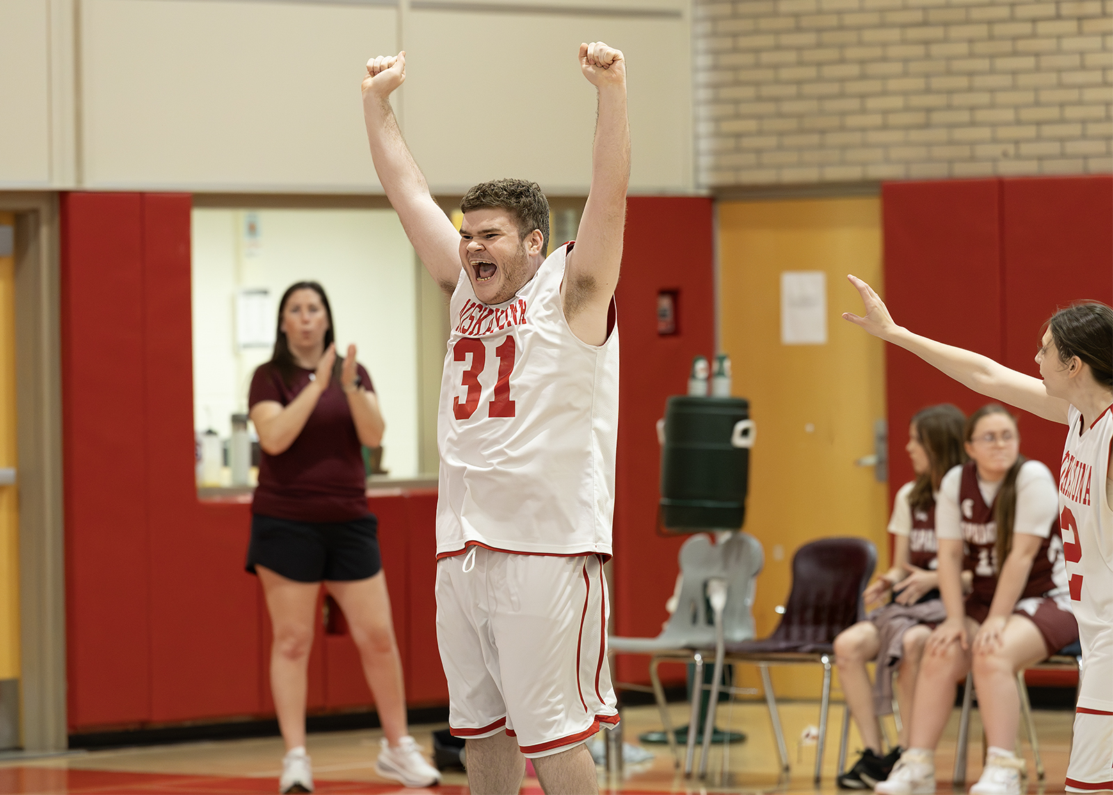 unified student celebrating after making a basket