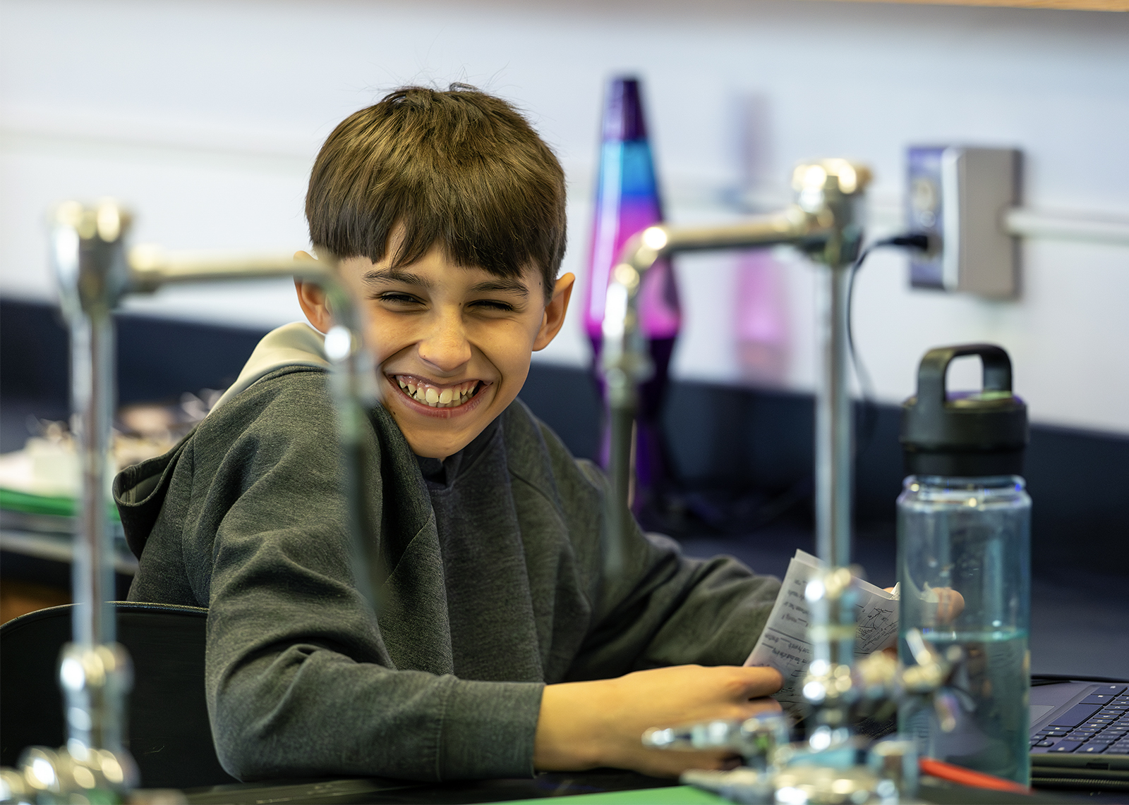middle schooler smiling in science class