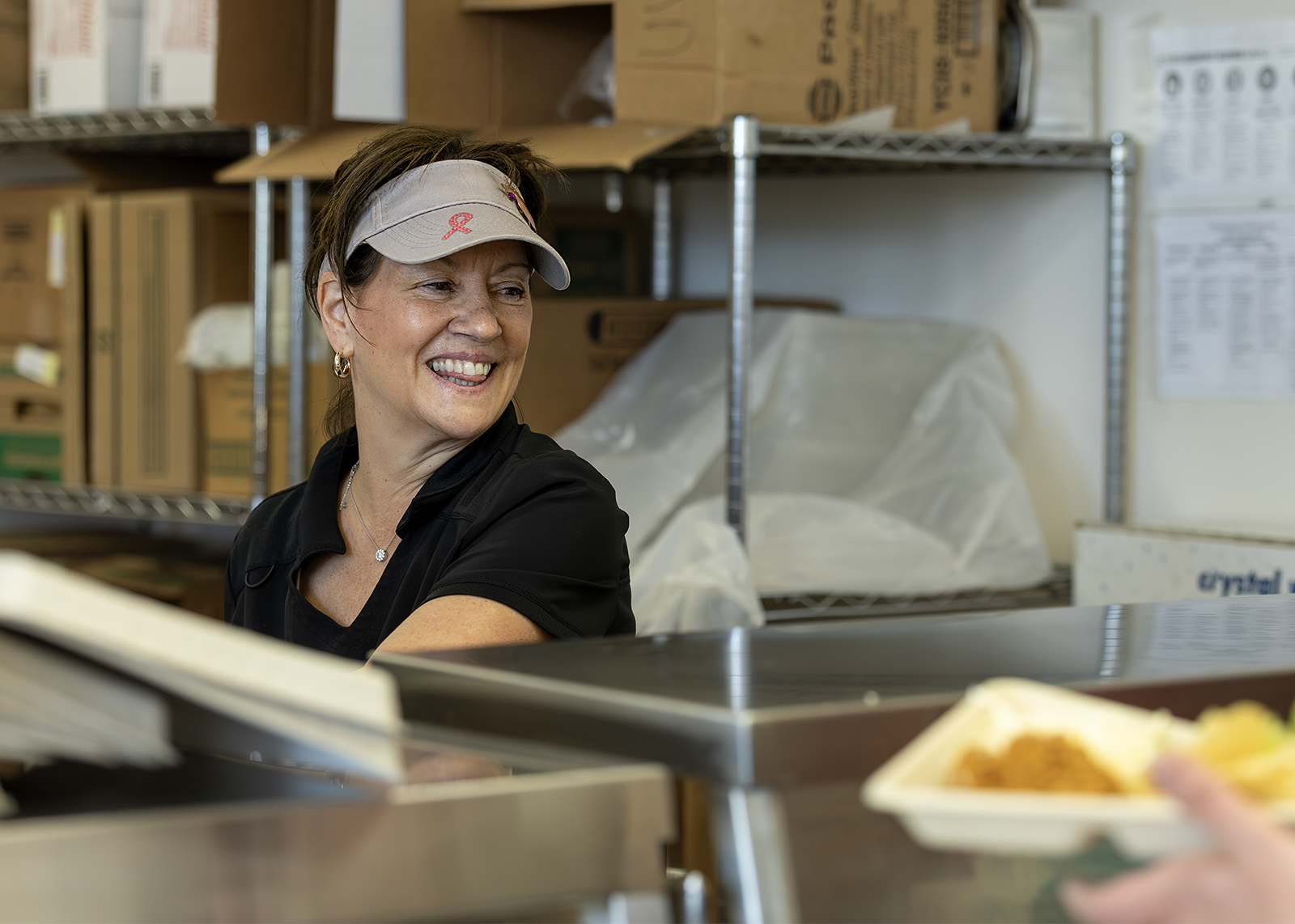 lunch staff smiling while serving trays