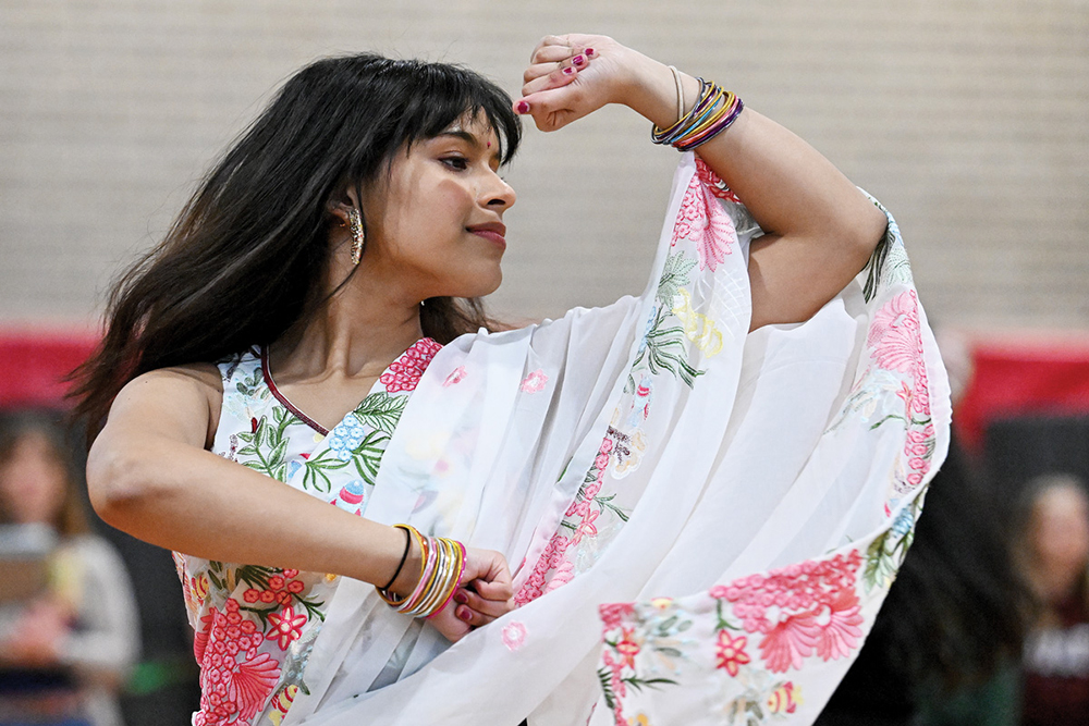 A teen wearing a sari performs a ceremonial dance.