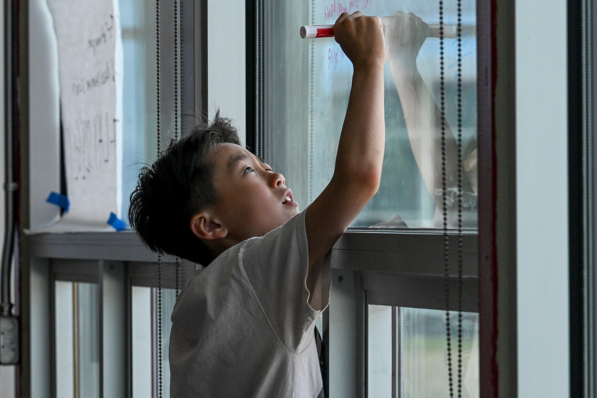 Male engineering student works on problem.