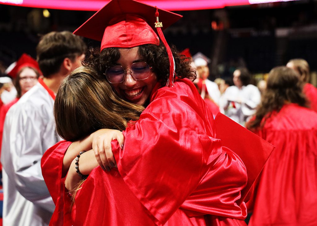happy graduates hugging.