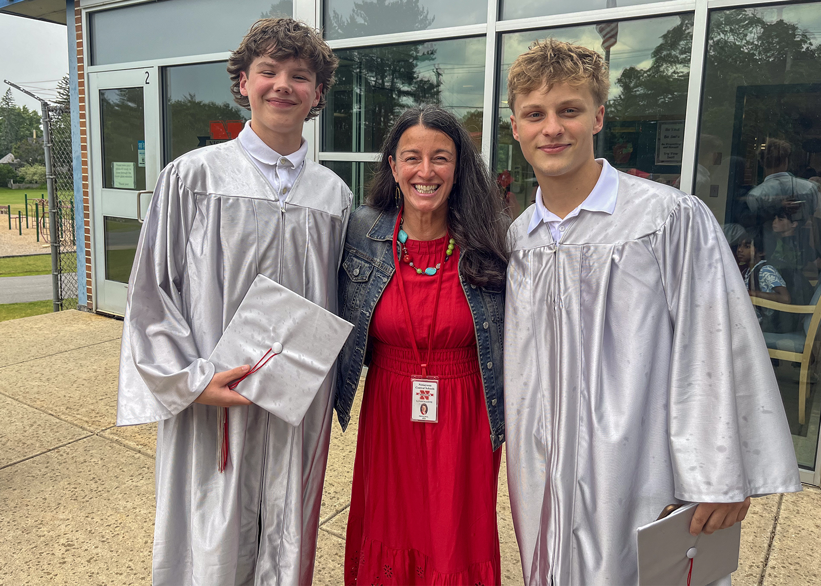 graduating seniors in caps and gowns with elementary school principal