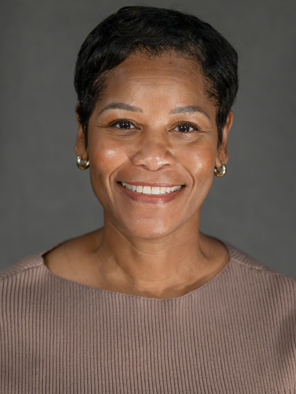 Professional photo of Latisha Barnett, smiling wearing a brown sweater