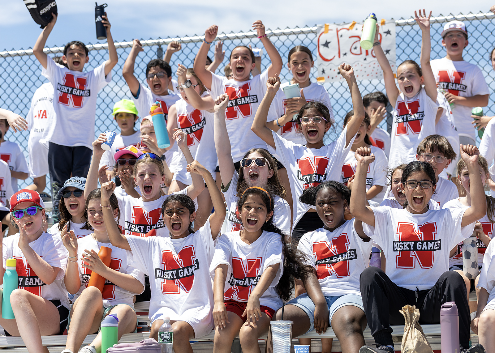 group of fifth graders cheering in bleachers at field day