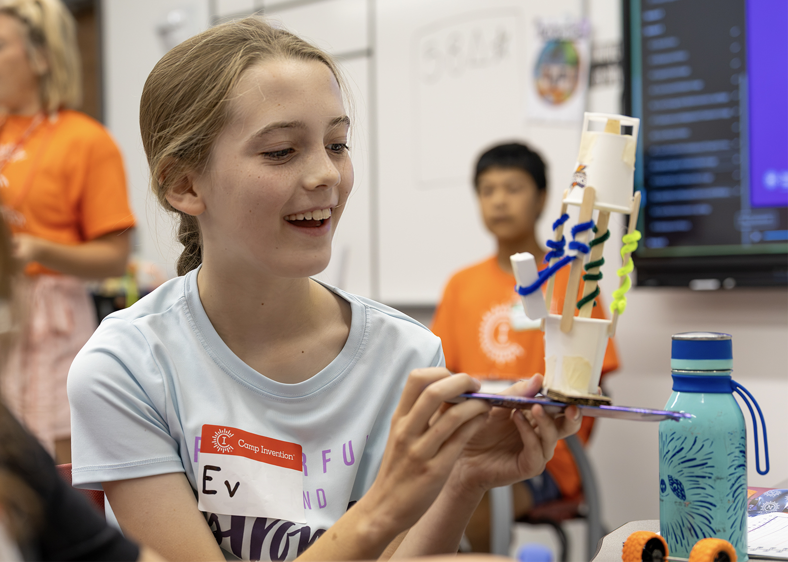 student smiles at camp invention build