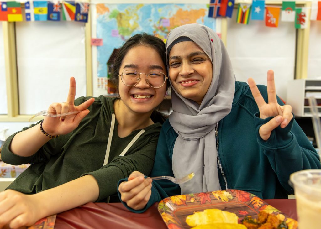 Two NHS students sitting at a table celebrating Thanksgiving.