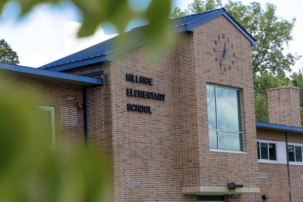 Exterior of Hillside Elementary through the trees.