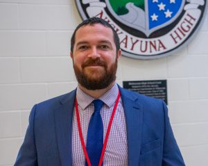 Professional photo of Joseph Coleman. He is smiling and in professional attire.