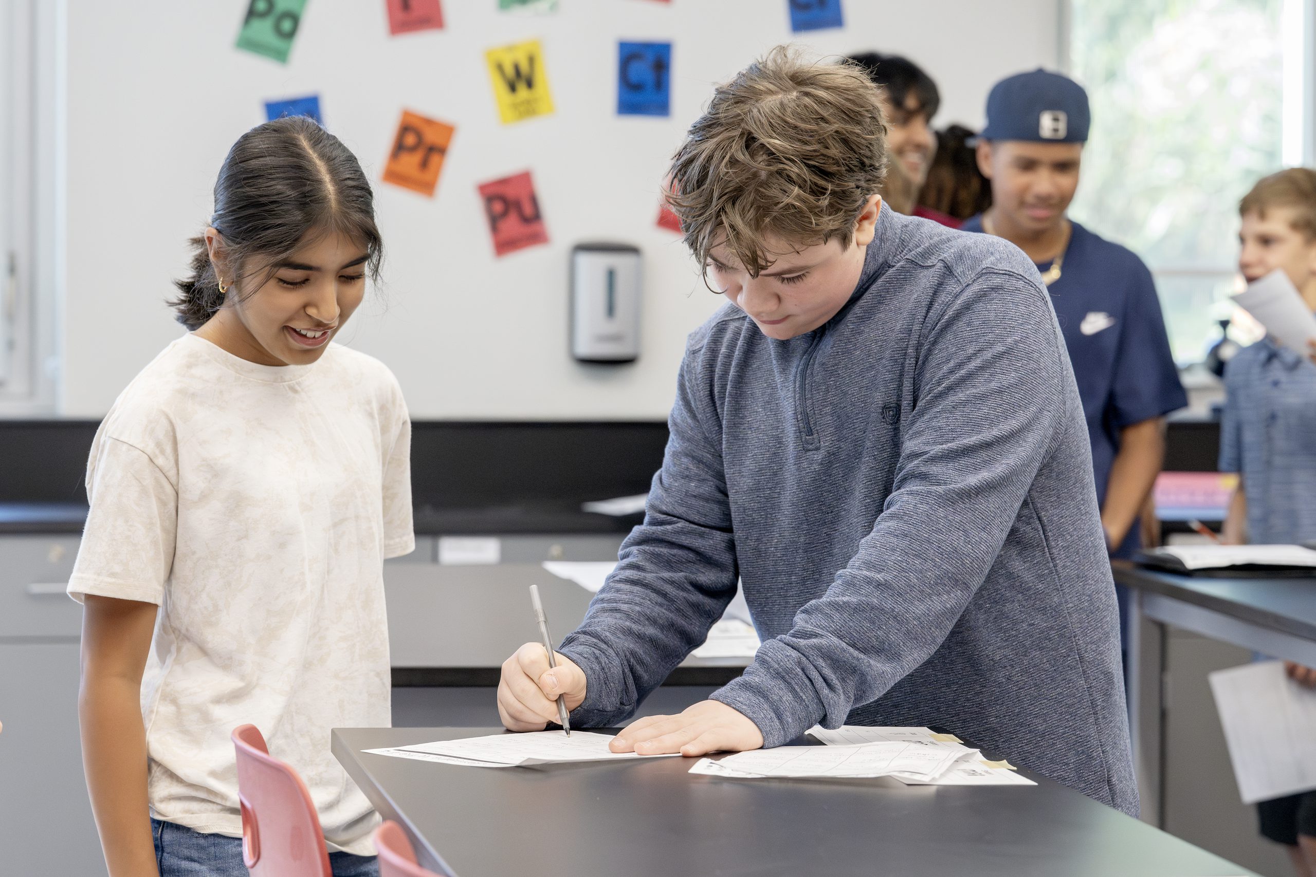 Two middle grade students collaborating in a new classroom environment.