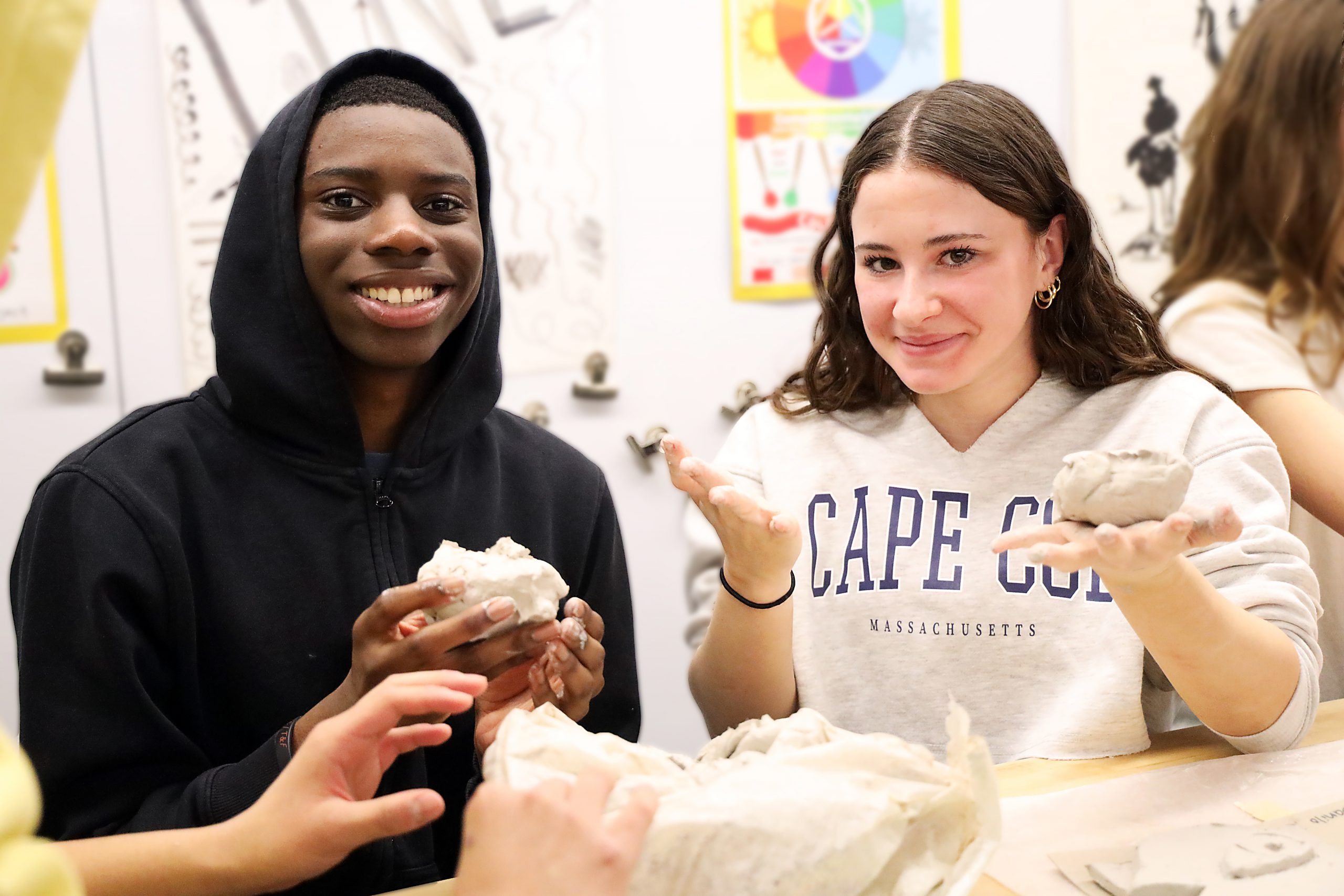 Two students working with modeling clay.