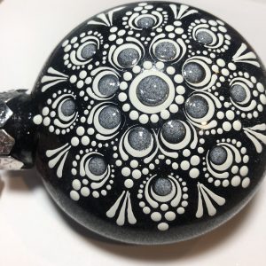 Black ornament with white Mandala design.