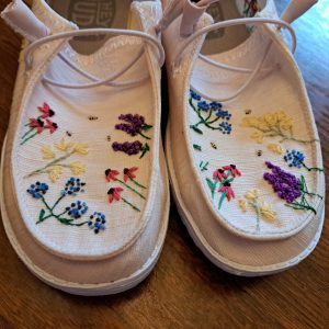 Shoes with embroidered flowers.