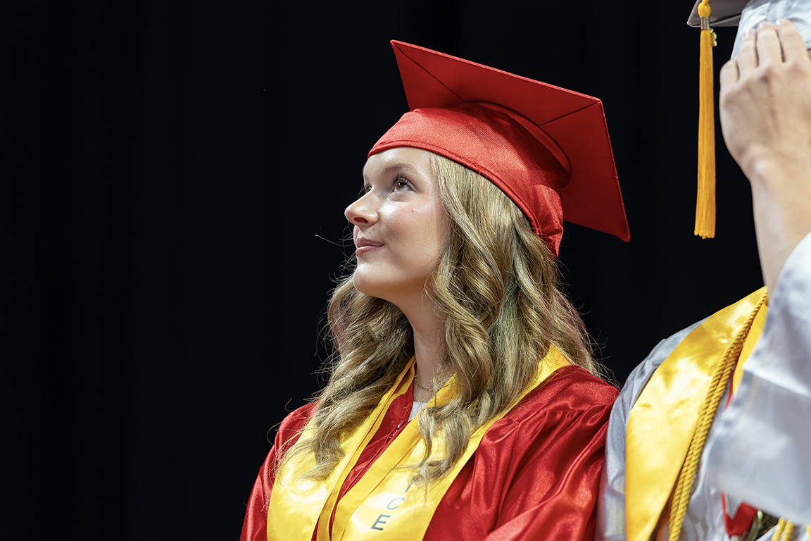 A graduate waiting to be called to receive a diploma.