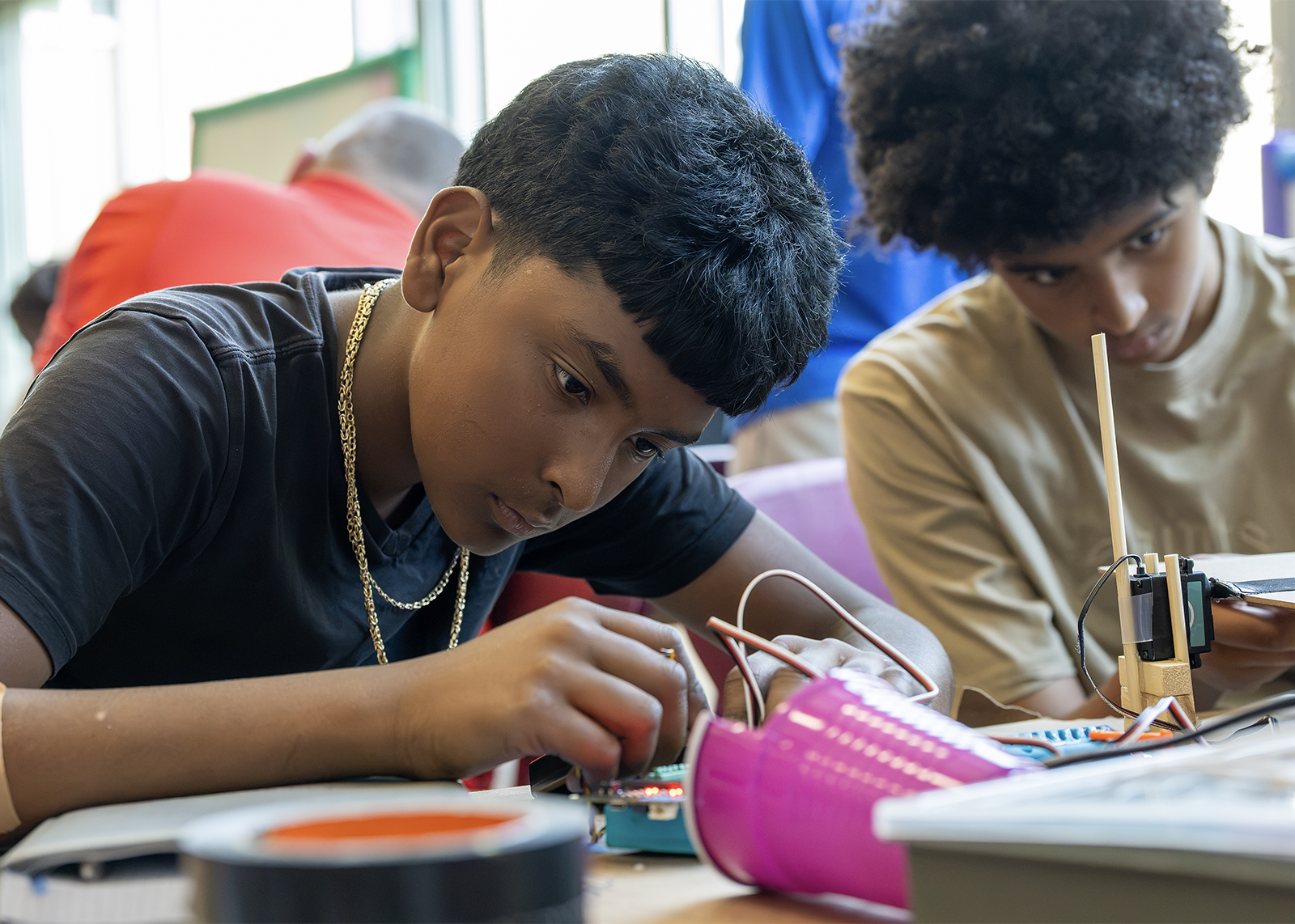 middle school student works at engineering camp