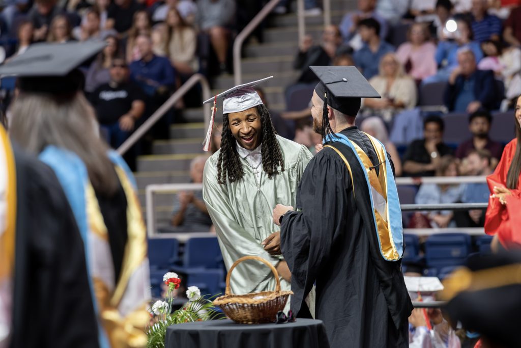Student walking across the stage at graduation