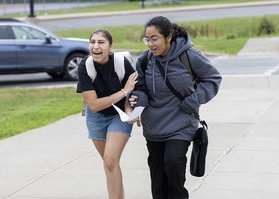 Two teens walking outside.