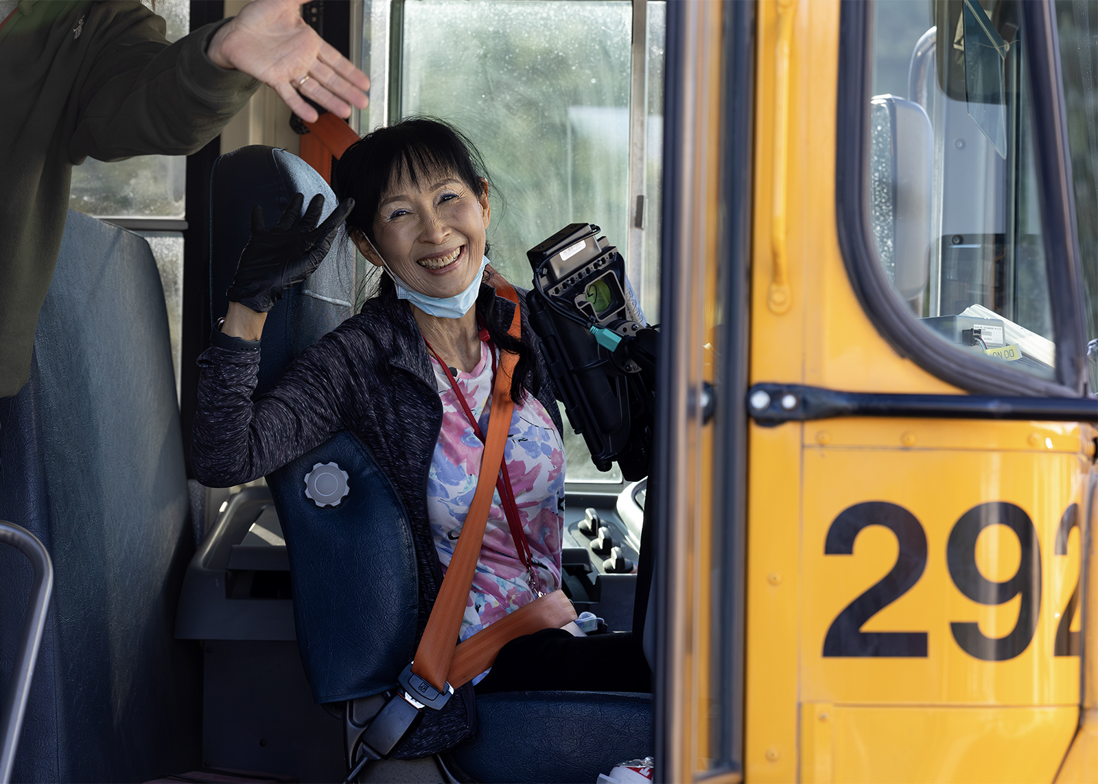 bus driver smiling and waving