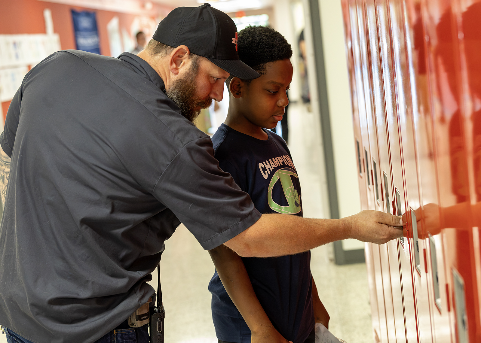 custodian helping student at locker