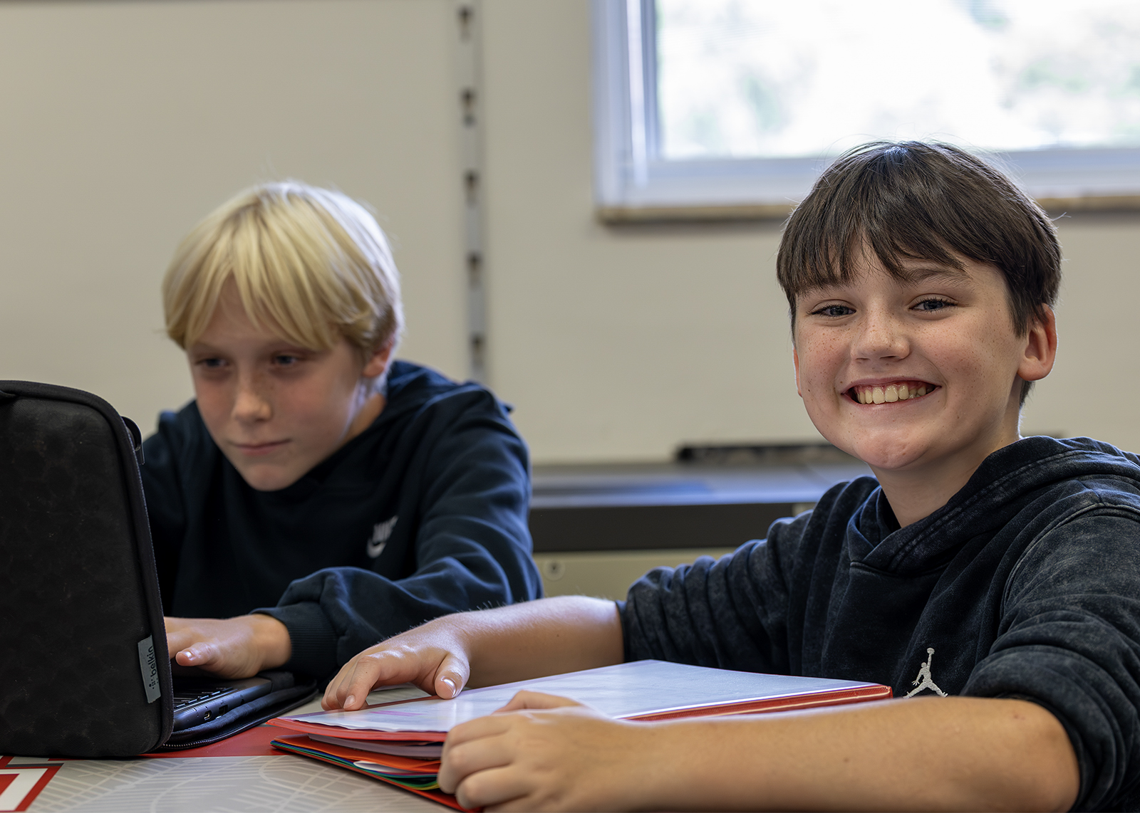 student smiling at camera during study hall