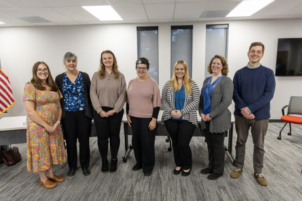 Seven staff members pose for group photo during Tenure Reception.